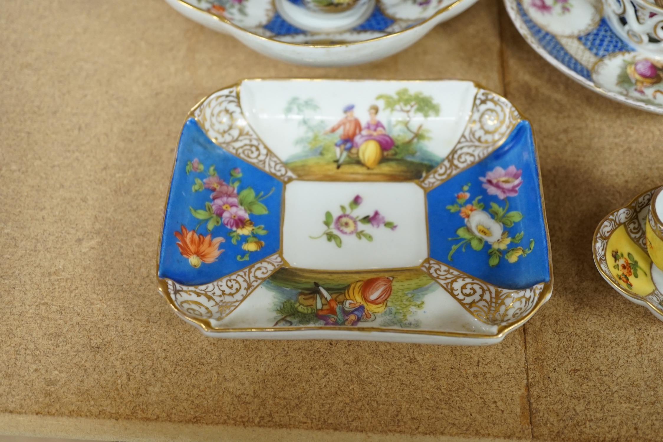 A Crown Dresden porcelain cup and trembleuse saucer, and three other Crown Dresden cups and saucers, largest 14.5cm wide. Condition - good